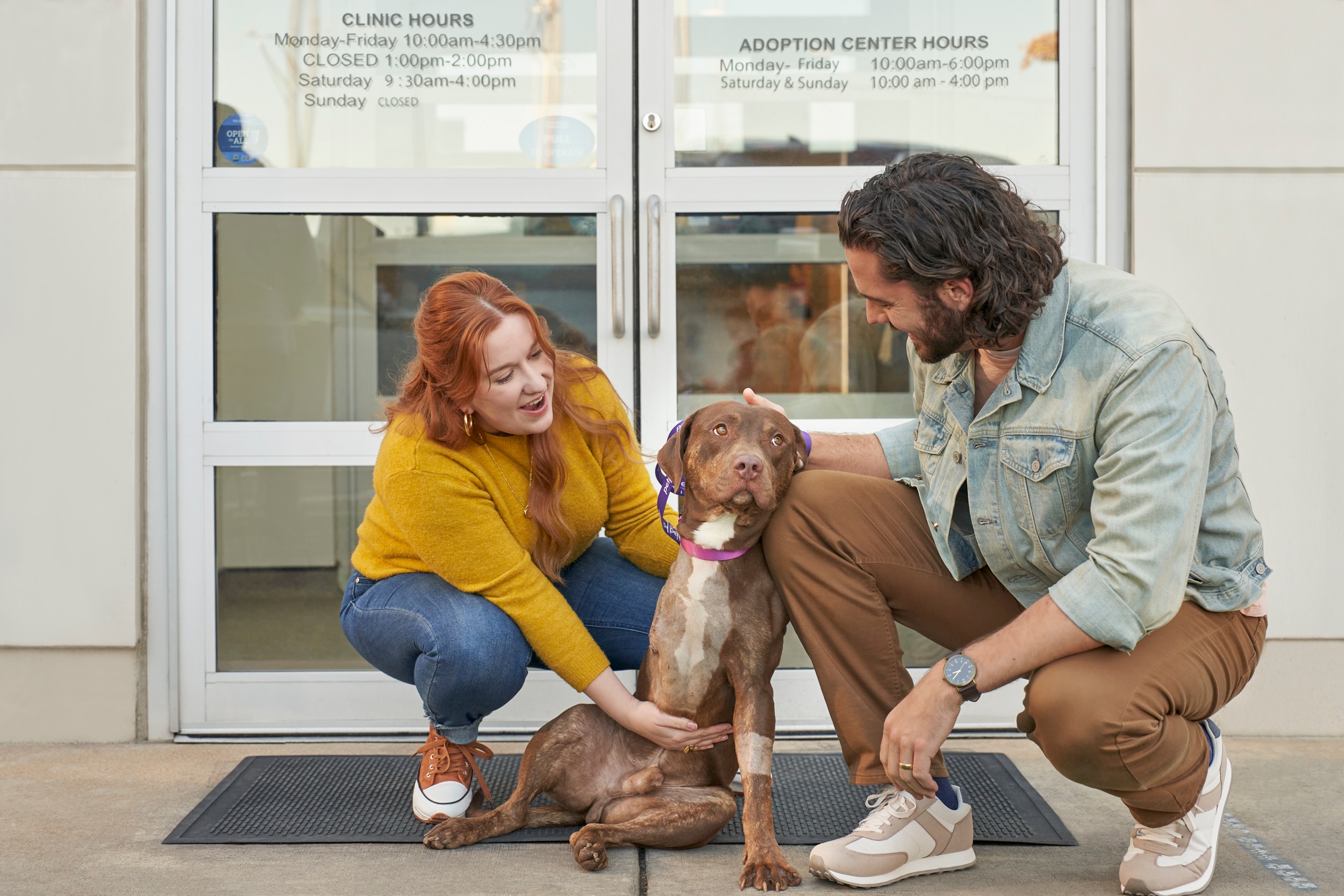 A couple with their dog at an adoption center