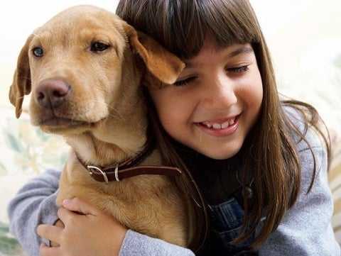 kid hugging dog